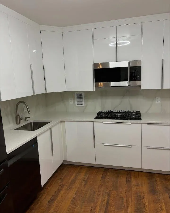 Restored kitchen with white cabinets after water damage in Floral Park